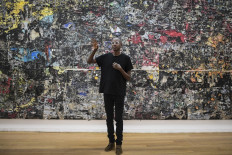 US artist Mark Bradford talks during the presentation of his exhibition 'AGORA' at the Serralves Museum of Cotemporary art Art in Porto, north of Portugal, on November 25, 2021.