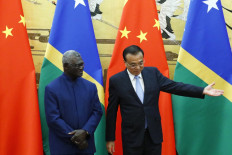 Solomon Islands Prime Minister Manasseh Sogavare (left) and Chinese Premier Li Keqiang attend a signing ceremony at the Great Hall of the People in Beijing on October 9, 2019. 