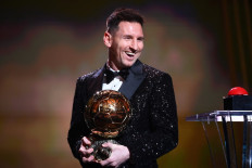 Paris Saint-Germain's Argentine forward Lionel Messi reacts after being awarded the the Ballon d'Or award during the 2021 Ballon d'Or France Football award ceremony at the Theatre du Chatelet in Paris on November 29, 2021. 