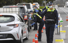 Police check the details of drivers in the small regional town of Kilmore, some 60 kilometers north of Melbourne, on Sept. 10, 2021, to prevent residents of locked-down Melbourne from travelling to COVID-free regions to reduce the transmission of the delta variant of coronavirus.