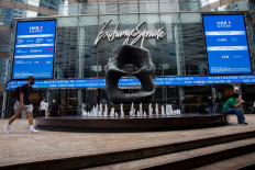 Digital signs display stock market information in the central district of Hong Kong, China, on Nov. 5, 2021.