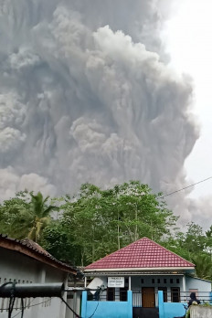 A massive column of hot ash erupts from Mount Semeru on Dec. 4, 2021 as viewed from Lumajang, East Java, in this handout photo from the National Disaster Mitigation Agency (BNPB).