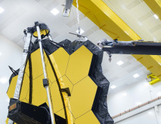 This handout image released by NASA on May 11, 2021 shows NASA's James Webb Space Telescope undergoing tests at Northrop Grumman in Redondo Beach, California. The world's largest and most powerful space telescope ever built unfolded its giant golden mirror for the last time on Earth on May 11, a key milestone before the $10 billion observatory is launched later this year. The 21 feet 4 inch (6.5 meter) mirror was commanded to fully expand and lock itself into place, NASA said -- a final test to ensure it will survive its million-mile (1.6 million kilometer) journey and is ready for its quest to discover the origins of the Universe.