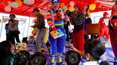 Red-nosed clowns entertain evacuees in an evacuation camp in Lumajang, East Java.