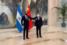 This screen grab made from video released by Chinese state broadcaster China Central Television (CCTV) on December 10, 2021 shows Laureano Ortega Murillo (left), Nicaraguan President Daniel Ortega's son and presidential advisor for Investments, Trade and International Cooperation, greeting China's Vice Foreign Minister Ma Zhaoxu during a ceremony in Tianjin after Nicaragua announced it had switched diplomatic allegiance from Taiwan to China. 