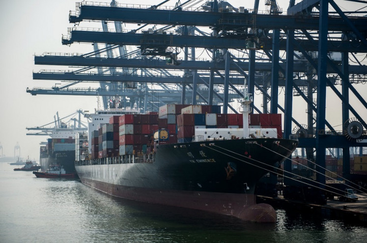 Container vessels are moored at the Jakarta International Container Terminal on Nov. 6, 2018.