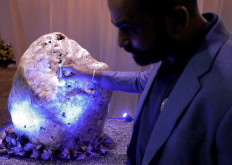 Gemological Institute of Ratnapura Director of research and development, Chamila Suranga, inspects the world's largest natural corundum blue sapphire, weighing 310 kilograms, which was found in a gem pit, at a private residence in Horana, Sri Lanka, December 12, 2021. 
