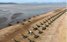 Uninviting beachfront: Anti-landing spikes stand along the coast of Taiwan's Kinmen Islands on Nov. 4, 2020, with Mainland China visible in the background.