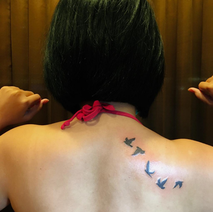 Flying high: Ananda Dessy Sukma Imanto shows the birds in flight tattooed on her back, which symbolize freedom. (Courtesy of Ananda Dessy Sukma Imanto)