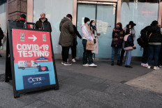 Groups of people line-up to get tested for Covid-19 in Times Square on December 05, 2021 in New York City. With the newly discovered omicron strain of Covid, health officials are urging people to get a vaccination or a booster and get tested for Covid. 