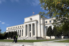 Security personnel walk past the US Federal Reserve building in Washington, DC. on Oct. 22, 2021.