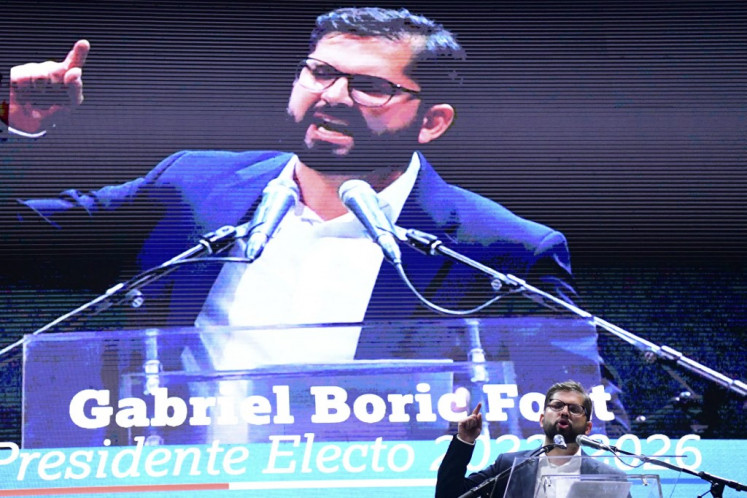Chilean president-elect Gabriel Boric addresses supporters following the official results of the runoff presidential election, in Santiago, on December 19, 2021. The streets of Santiago exploded in celebration after leftist Gabriel Boric was declared Chile's new president with an unexpectedly large victory over his far-right rival in a polarizing race. Boric, 35, garnered nearly 56 percent of the vote compared to 44 percent for ultra-conservative Jose Antonio Kast, who congratulated the 