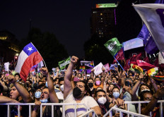 Supporters of Chilean president-elect Gabriel Boric celebrate following the official results of the runoff presidential election, in Santiago, on December 19, 2021. With more than 99 percent of ballots counted, leftist lawmaker Gabriel Boric, 35, became Chile's youngest-ever president leading with 55.86 percent to 44 percent for his far-right rival Jose Antonio Kast, said the Servel website, with a star to indicate the winner.