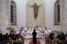 Children perform at the Mother Teresa Cathedral during the midnight Christmas mass in Pristina, Kosovo, on December 25, 2021.