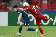 Thailand's Supachok Sarachat (left) fights for the ball with Vietnam's Nguyen Phong Hong Duy during the first leg of the AFF Suzuki Cup 2020 football semi-final match between Vietnam and Thailand at the National Stadium in Singapore on December 23, 2021. 