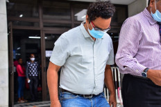 In this file photo taken on August 18, 2020 Sunil Kumar Nandeshwar (L), the captain of the MV Wakashio bulk carrier that had run aground, leaves from the court after he and his deputy was charged under the piracy and maritime violence act in Port Louis, Mauritius.