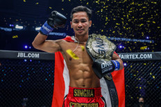 Thai fighter Superbon gestures with the ONE Featherweight Kickboxing World Championship belt after defeating Giorgio Petrosyan on Oct. 15, 2021.