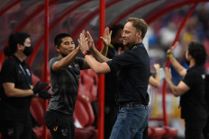 Thailand's head coach Alexandre Polking (2nd right) celebrates with his team after winning the first leg of the AFF Suzuki Cup 2020 football final match against Indonesia at the National Stadium in Singapore on December 29, 2021. 