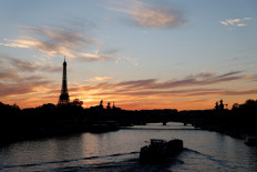 The sun sets behind the Eiffel Tower and the river Seine in Paris Oct. 19, 2021.
 