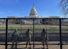 In this file photo taken on January 09, 2021, US National Guard soldiers guard the grounds of the US Capitol from behind a security fence in Washington, DC.