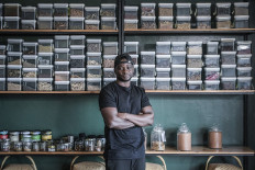 30-year-old Congolese chef Dieuveil Malonga poses inside his restaurant 'Meza Malonga' in Rwanda's capital Kigali, on October 27, 2021.