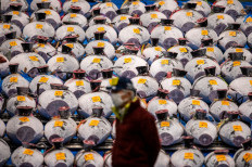 A wholesaler stand in front of the lined up frozen tuna during the New Year's auction at Toyosu fish market in Tokyo, Japan on January 5 2022. 