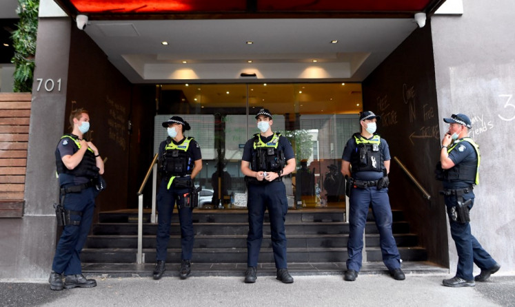 Police stand guard at a government detention centre where Serbia's tennis champion Novak Djokovic is reported to be staying in Melbourne on January 7, 2022, after Australia said it had cancelled the entry visa of Djokovic, opening the way to his detention and deportation in a dramatic reversal for the tennis world number one. 