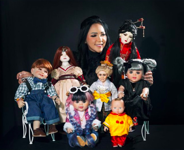 Happy 'family': Furi Harun poses with several dolls from her collection. The collector is said to have fuelled the spirit doll craze among Indonesian celebrities. (Courtesy of Instagram/Furi Harun)