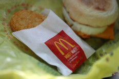 The McDonald's logo is displayed on the packaging of a hash brown at a McDonald's restaurant on January 30, 2018 in San Francisco, California. McDonald's reported better-than-expected fourth quarter earnings with global same-store sales growing at the fastest pace in six years. Fourth quarter net income dropped 41 percent to $698.7 million, or 87 cents per share, compared to $1.19 billion, or $1.44 per share one year ago. 