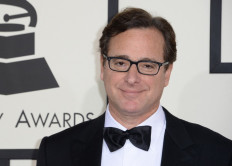  In this file photo taken on January 26, 2014 Bob Saget arrives on the red carpet for the 56th Grammy Awards at the Staples Center in Los Angeles, California. Bob Saget, the US comedian who delighted millions as the star of television's 