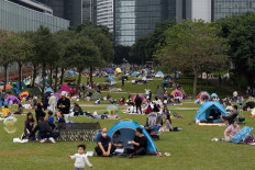 People gather on a quiet Sunday afternoon on the grounds outside the Central Government Complex in Hong Kong’s Admiralty district on Jan. 9, 2022.