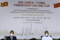 Chinese Foreign Minister Wang Yi (left) and Sri Lanka President Gotabaya Rajapaksa attend a sailing event on the occasion of the 65th anniversary of diplomatic relations between the two countries during Wang Yi's visit to the Colombo Port city project in Colombo, Sri Lanka, on Jan. 9.
