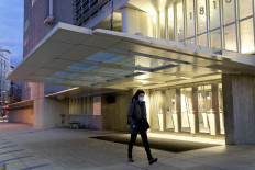A pedestrian walks past the World Bank headquarters in Washington, DC, on Jan. 10, 2022.