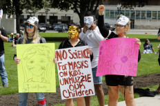 A group of anti-vaxxers join demonstrators during a Freedom Rally in support of First Amendment rights and to protest against Governor Gretchen Whitmer, outside the Michigan State Capitol in Lansing, Michigan on May 15, 2021. 