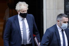 Partygoer: British Prime Minister Boris Johnson is pictured wearing a face covering on Wednesday ahead of the weekly session of Prime Minister’s Questions at the House of Commons. 

