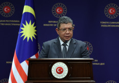 Malaysian Minister of Foreign Affairs Saifuddin Abdullah speaks during a joint press conference with Turkish Foreign Minister after their meeting in Ankara on December 20, 2021. 