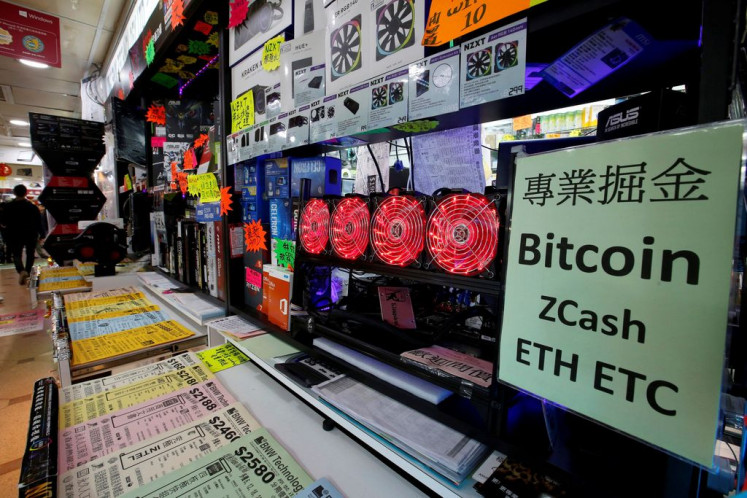Cool currency: A cryptocurrency mining computer equipped with four cooling fans is seen on display at a computer mall in Hong Kong, China, on Jan. 29, 2018. 