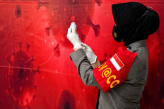 A police health worker prepares to give the Moderna COVID-19 coronavirus vaccine at a makeshift clinic at the Aceh Museum in Banda Aceh on January 17, 2022.