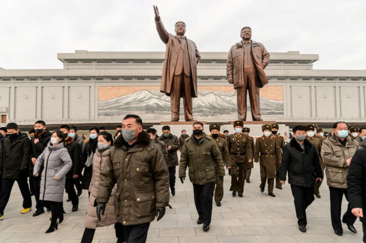 The leaders: People visit the statues of President Kim Il Sung and chairman Kim Jong Il on Mansu Hill in Pyongyang on January 1, 2022.