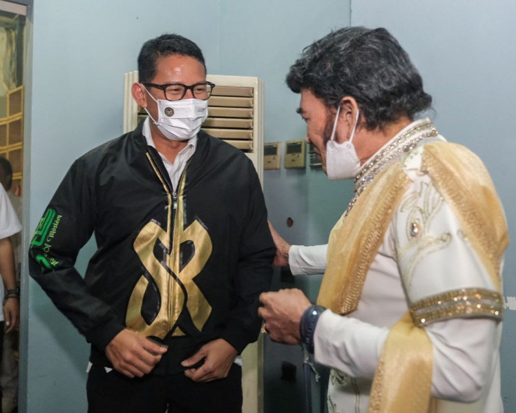 Greetings: Minister of Tourism and Creative Economy Sandiaga Uno (left) talks to dangdut legend Rhoma Irama (right) backstage at a gig in Jakarta, in December 2021.