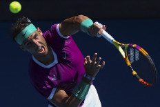 Spain's Rafael Nadal serves against France's Adrian Mannarino during their men's singles match on day seven of the Australian Open tennis tournament in Melbourne on Jan.23, 2022.