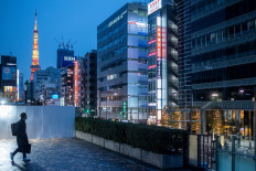 A man walks on a footbridge in the Minato district of Tokyo on Jan. 23, 2022.