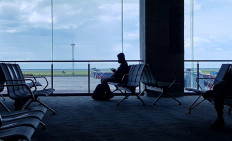 A man sitting at the I Gusti Ngurah Rai International Airport, Bali on Friday, 22 Jan.2022.