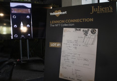 A NTF (non-fungible token) of the Gibson Les Paul guitar with the mention "To Julian from Daddy" gifted by John Lennon to his son Julian and a print of "Hey Jude" notes written by Paul McCartney are seen during the media preview of part of "Lennon Connection: The NFT Collection" auction featuring cherished Beatles and John Lennon memorabilia from the private collection of Julian Lennon, at Julien's Auctions, in Beverly Hills, California, January 25, 2022. Beatles fans won't be able to touch them, but they can soon get their virtual hands on personal memorabilia from John Lennon's son Julian in the form of NFTs. 