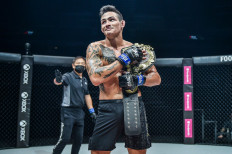 ONE featherweight world champion Thanh Le poses with the championship belt inside the Circle after defeating predecessor Martin Nguyen in 2020.