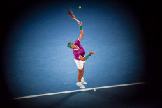 Spain's Rafael Nadal serves against Italy's Matteo Berrettini during their men's singles semi-final match on day twelve of the Australian Open tennis tournament in Melbourne on January 28, 2022. 