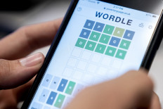 Game on!: A person plays online word game Wordle on a mobile phone in Washington, DC, the United States on Jan. 11. The New York Times announced on Jan. 31 that it had bought the game for a seven figure sum.