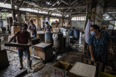 Employees make tofu on Jan. 20, 2022 at a cottage factory in Surabaya.