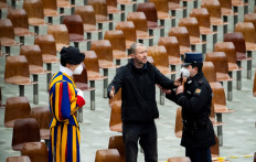A man is escorted out by the Vatican gendarmes, after he shouted during the weekly general audience of Pope Francis in the Paul VI hall at the Vatican on February 2, 2022.
