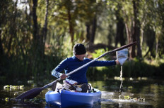Omar Menchaca collects plastic from the Xochimilco canals in Mexico City on January 25, 2022.